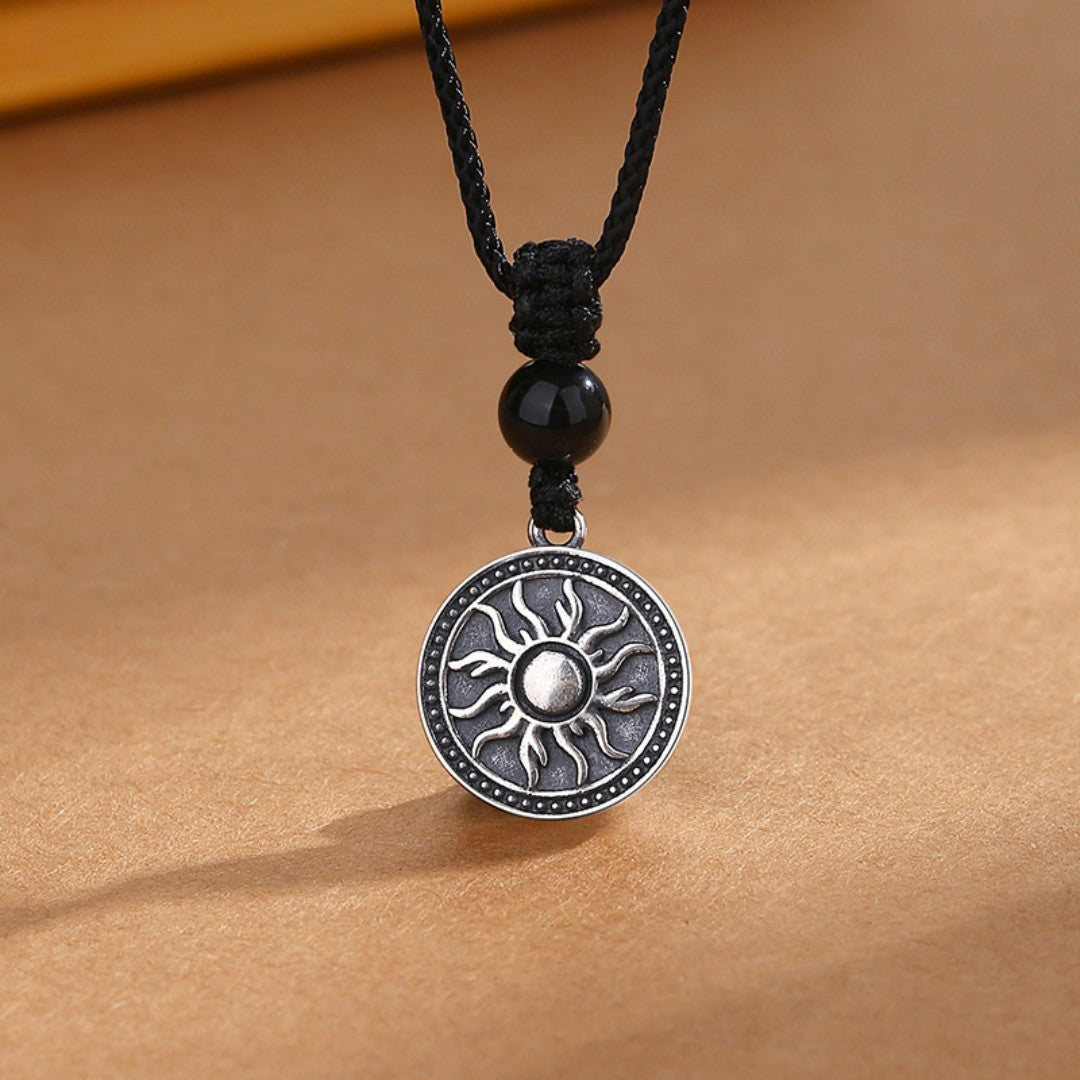 Sterling silver sun symbol pendant necklace with a black obsidian bead