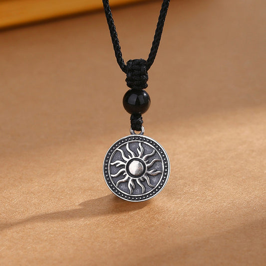 Sterling silver sun symbol pendant necklace with a black obsidian bead
