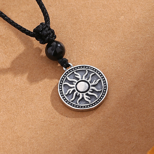 Sterling silver sun symbol pendant necklace with a black obsidian bead