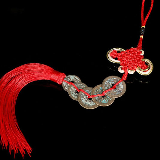 Red Chinese knot with five antique coins hanging from it (Feng Shui charm)