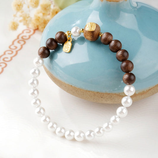 Agarwood bead bracelet with a gold-decorated Tibetan goddess carving bead and white shell beads