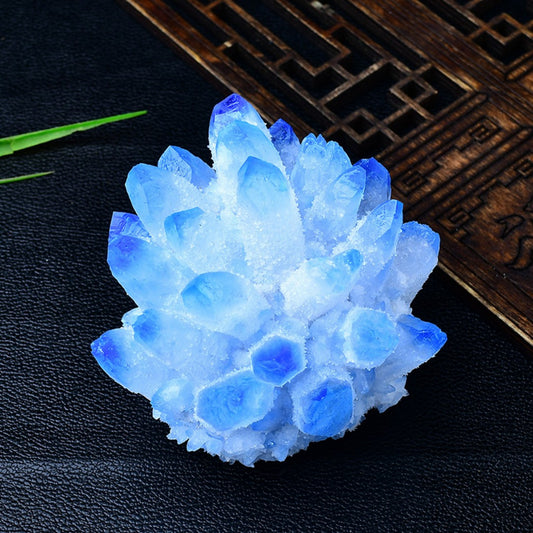 Blue quartz crystal cluster on green peridot chip bed with wooden display