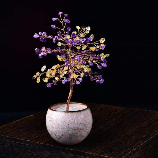 Feng shui crystal tree combining amethyst and citrine leaves in pink ceramic bowl