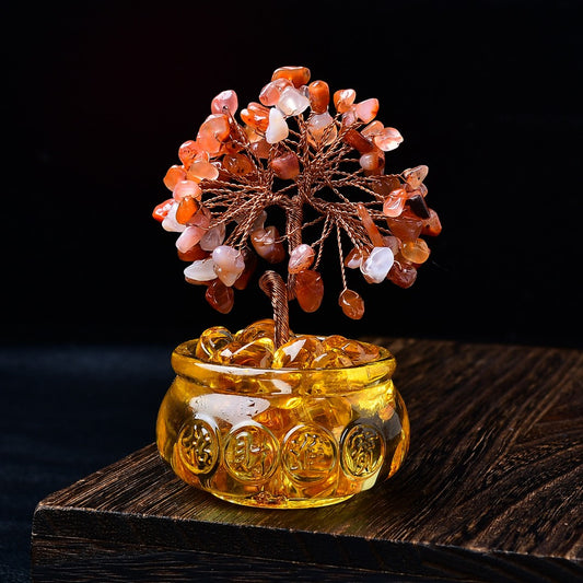 Feng shui crystal tree with red agate leaves in golden money pot with gold ingots