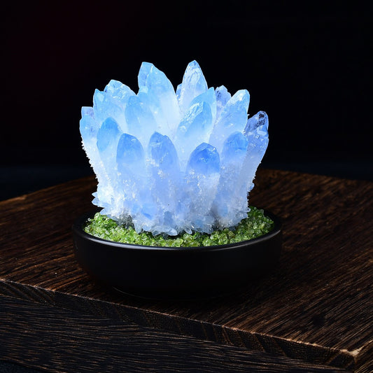 Blue quartz crystal cluster on green peridot chip bed with wooden display