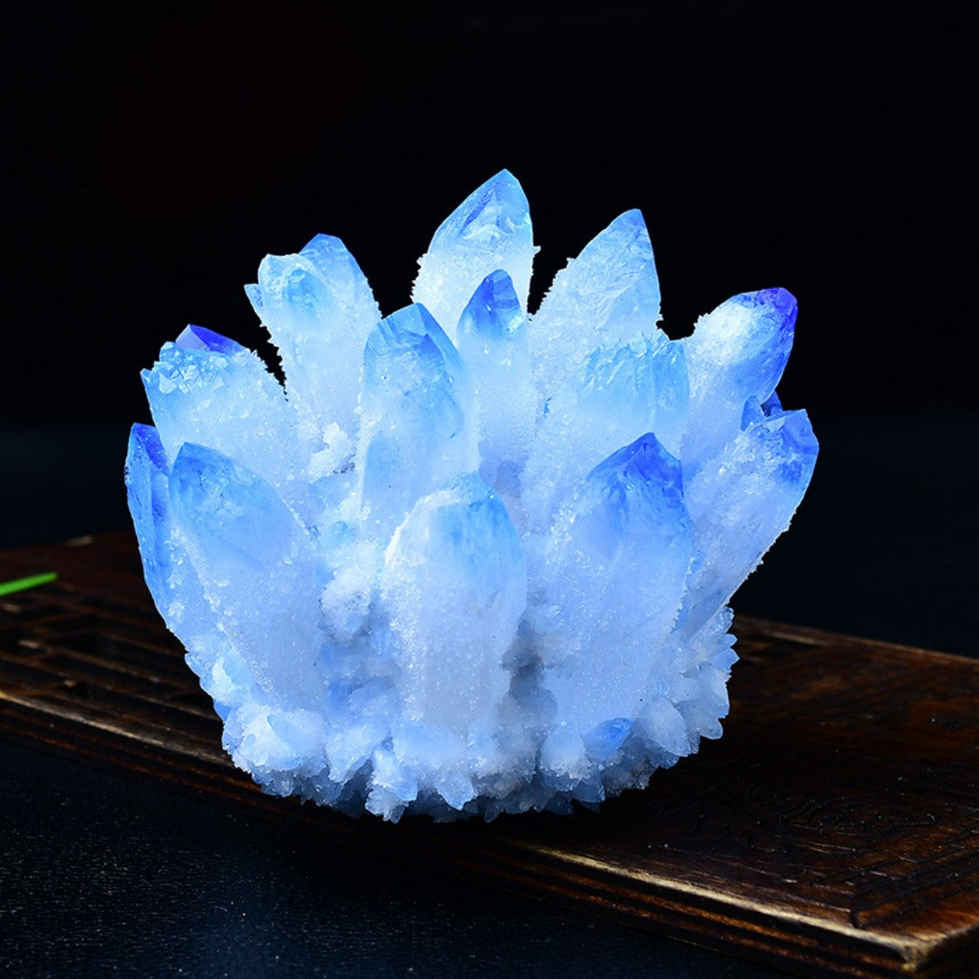 Blue quartz crystal cluster on green peridot chip bed with wooden display