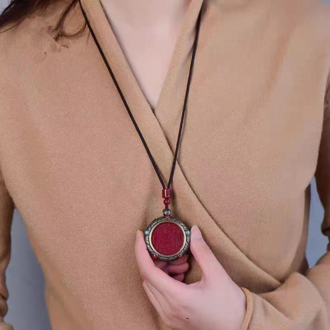 Natural cinnabar mountain spirit spinning amulet pendant with engraved Taoist symbol