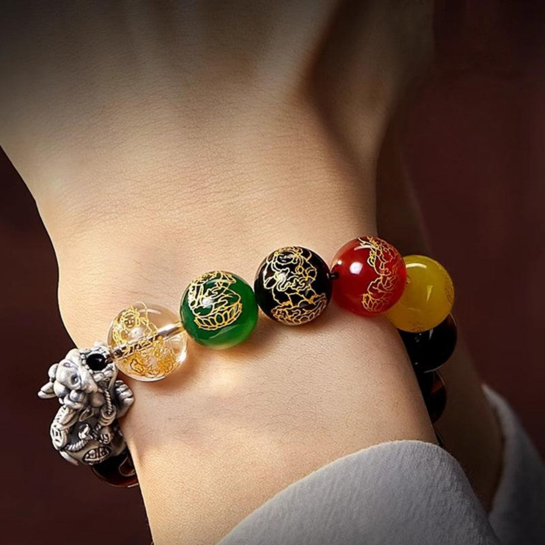 Brown Tiger’s Eye bead bracelet with five multicolor carved wealth god beads and a silver Pixiu charm