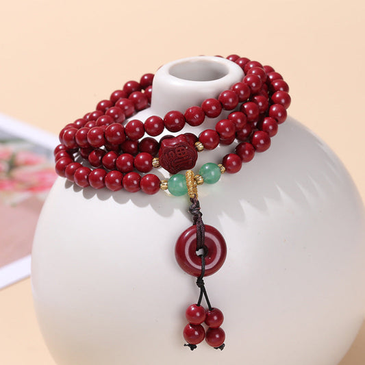 Multi-layer cinnabar bracelet with Pixiu, Peace Buckle, and Fortune Pouch charms inspired by Eastern symbolism