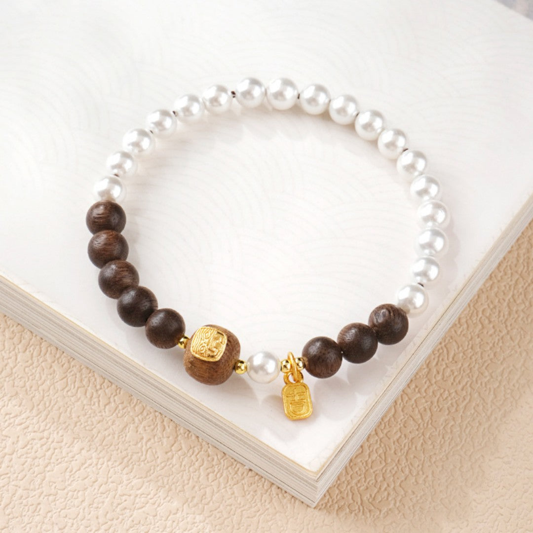 Agarwood bead bracelet with a gold-decorated Tibetan goddess carving bead and white shell beads
