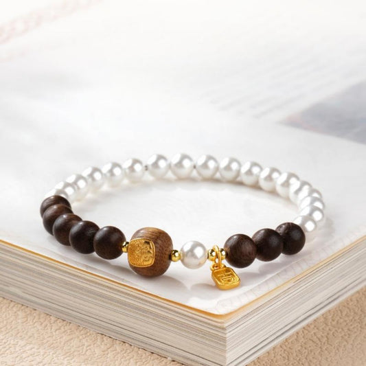 Agarwood bead bracelet with a gold-decorated Tibetan goddess carving bead and white shell beads