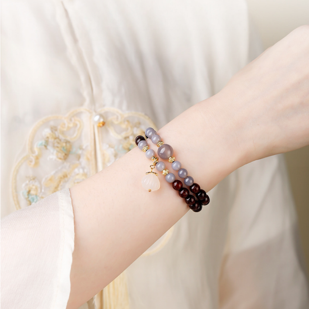 Styled: double-wrap bracelet layered with other bracelets — wrist shot