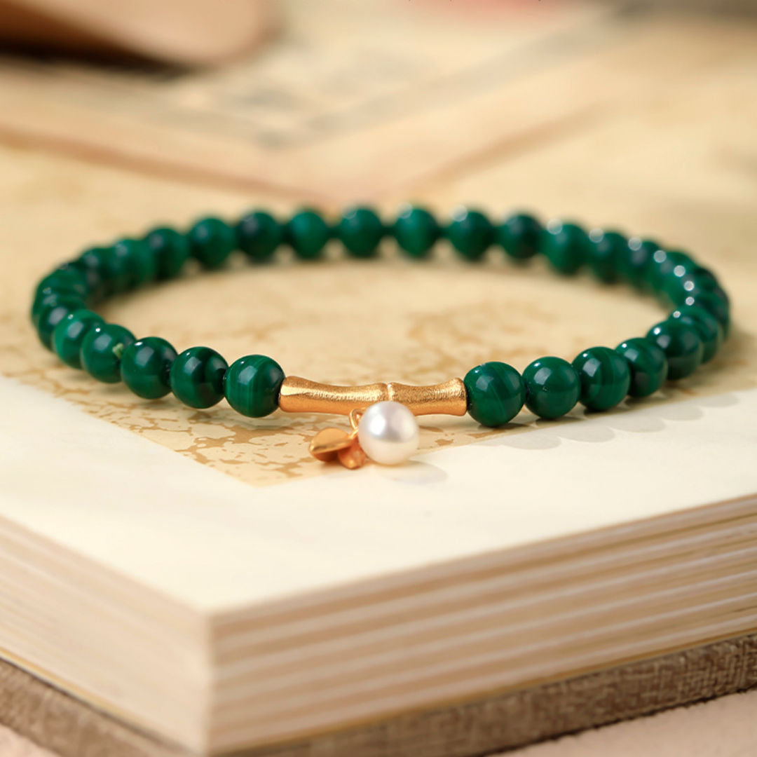 Green malachite bead bracelet with gold bamboo spacers and a white shell bead