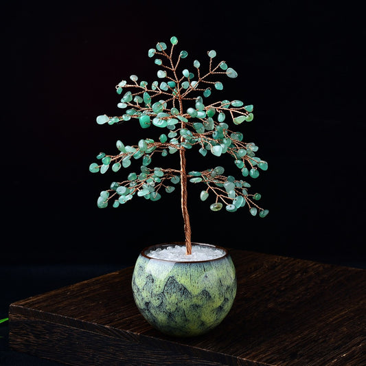 Feng shui tree with green aventurine leaves in glazed ceramic bowl filled with clear quartz chips