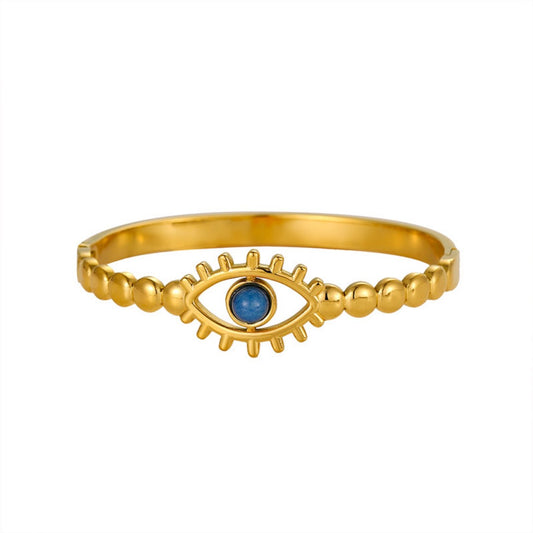 Gold evil eye cuff bracelet with a blue crystal “eye” bead