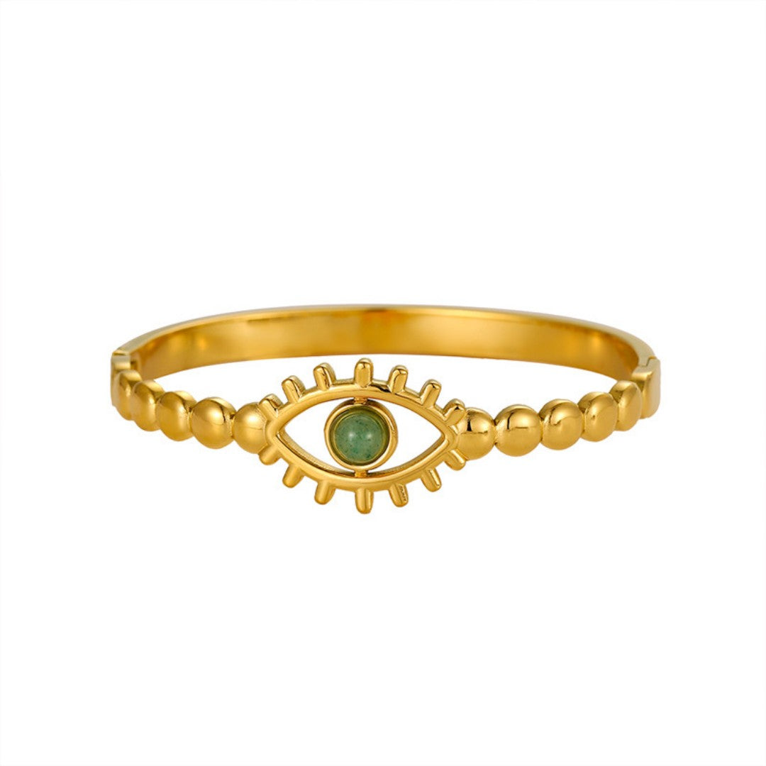 Gold evil eye cuff bracelet with a green crystal bead as the eye's center